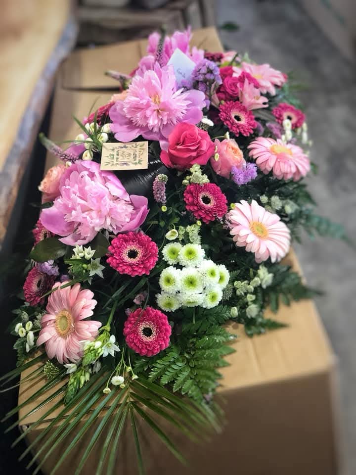 Une gerbe de fleurs réalisée pour un décès dans les tons roses